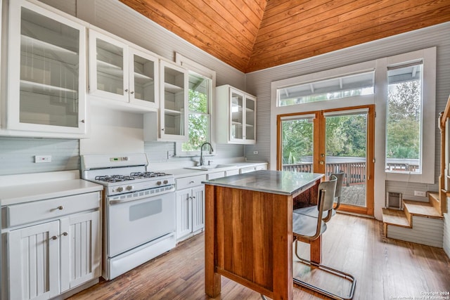 kitchen with gas range gas stove, a center island, and white cabinets