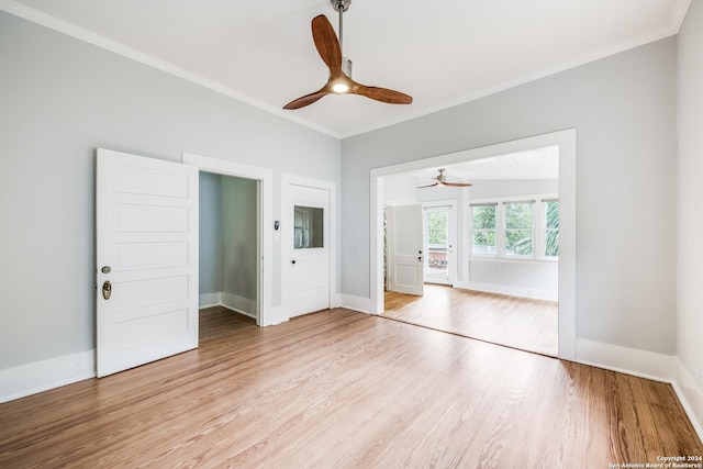 interior space featuring light hardwood / wood-style flooring, ceiling fan, and ornamental molding