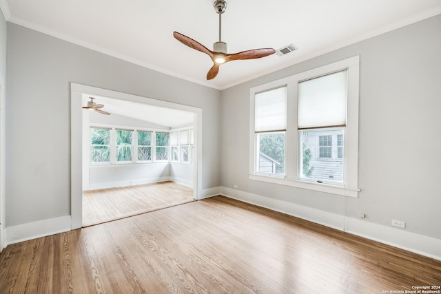 spare room featuring hardwood / wood-style flooring, ceiling fan, and crown molding