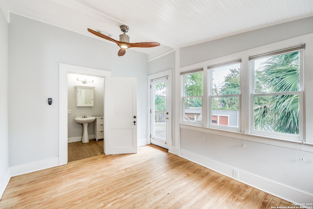 interior space with light wood-type flooring, ceiling fan, and sink