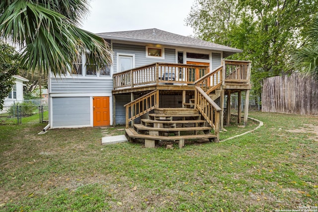 back of house featuring a yard and a deck