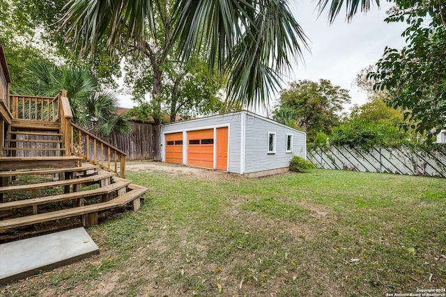 view of yard featuring a garage and an outdoor structure