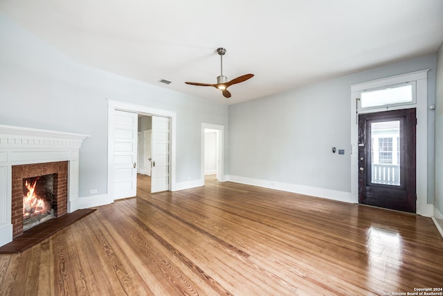 unfurnished living room with ceiling fan and hardwood / wood-style flooring