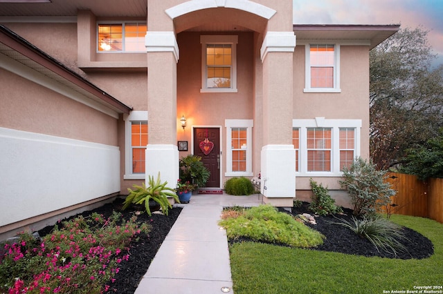 view of exterior entry at dusk