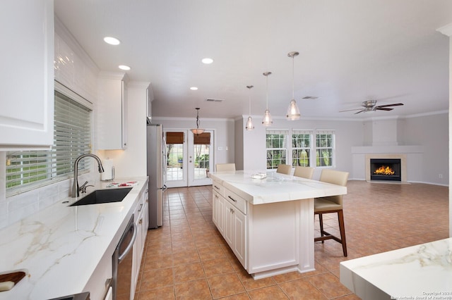 kitchen featuring a kitchen island, a healthy amount of sunlight, and appliances with stainless steel finishes