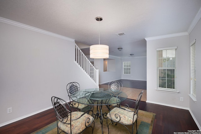 dining area featuring crown molding and dark hardwood / wood-style flooring