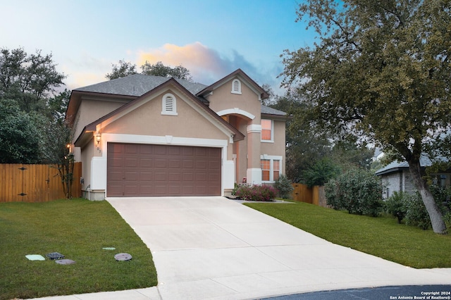 view of front of home with a lawn and a garage