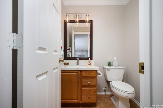 bathroom with tile patterned flooring, vanity, toilet, and crown molding