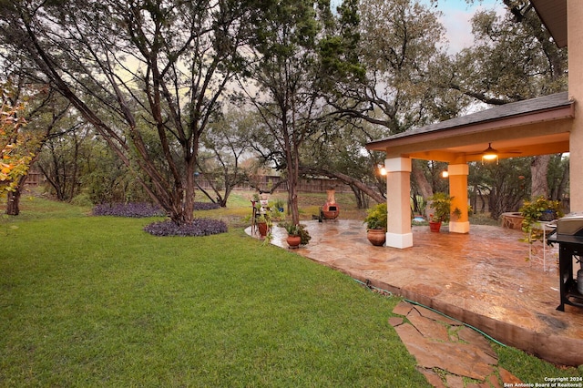 yard at dusk with a patio