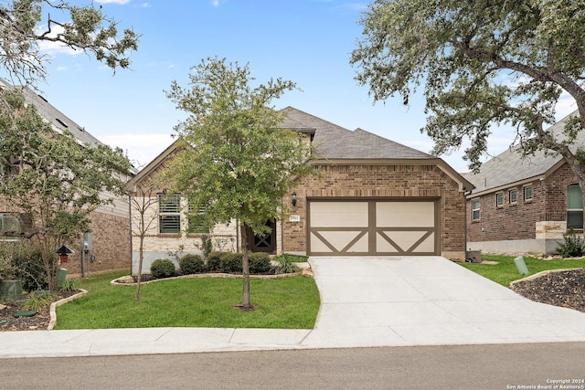 view of front of property featuring a garage and a front yard