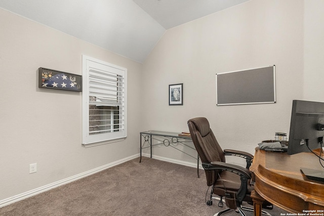 carpeted home office with lofted ceiling