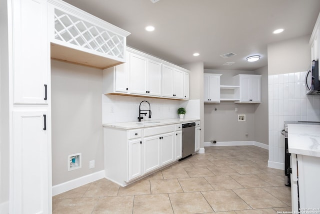 kitchen featuring sink, white cabinetry, and light tile patterned flooring