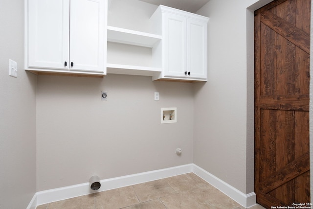 laundry room featuring electric dryer hookup, cabinets, hookup for a gas dryer, washer hookup, and light tile patterned flooring