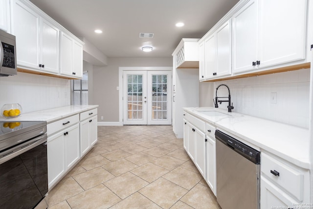 kitchen featuring white cabinetry, sink, french doors, and appliances with stainless steel finishes