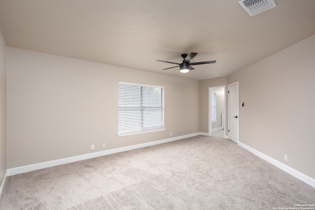 empty room with ceiling fan and light colored carpet