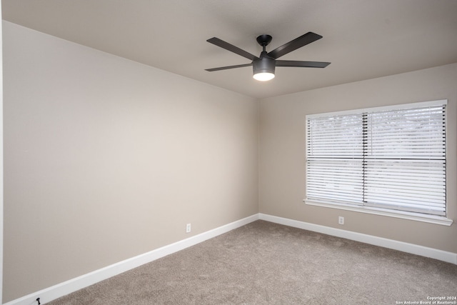 carpeted empty room with ceiling fan