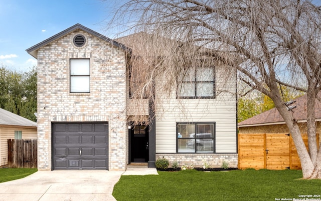 view of front of home featuring a garage and a front yard