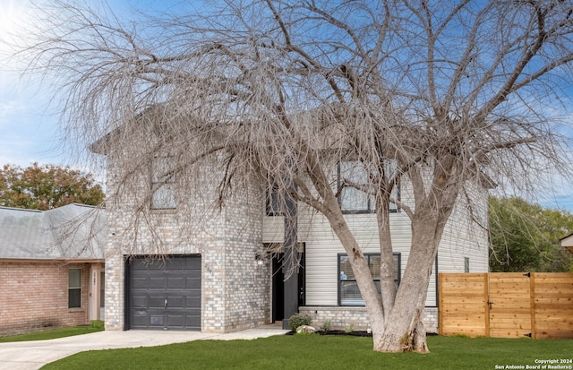 view of front facade with a front yard and a garage