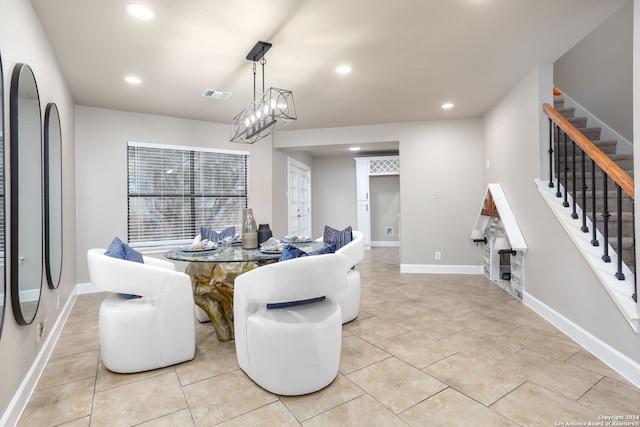 tiled dining area featuring a chandelier