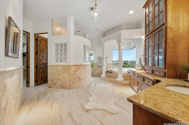 bathroom featuring vanity and ornate columns