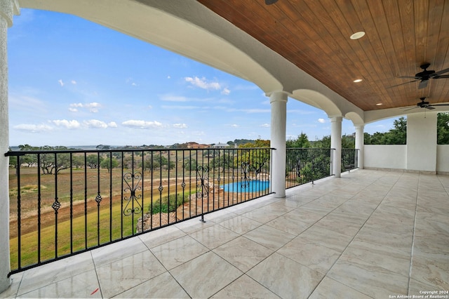 view of patio / terrace with a balcony and ceiling fan