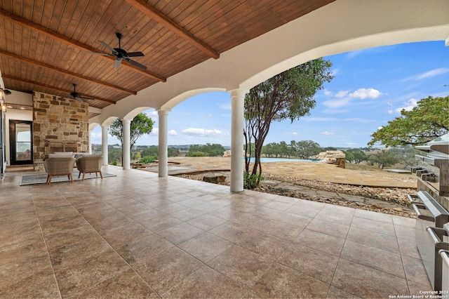 view of patio / terrace with ceiling fan and a water view