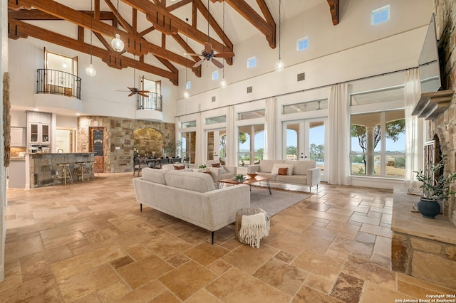 living room with french doors, high vaulted ceiling, ceiling fan, and beam ceiling