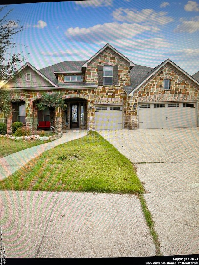 view of front of house featuring a garage and a front lawn