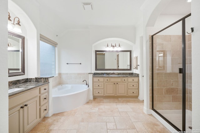 bathroom featuring separate shower and tub, vanity, and ornamental molding