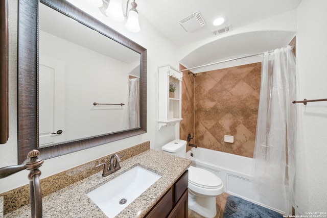 full bathroom with vanity, shower / bath combination with curtain, and toilet