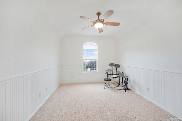 empty room featuring ceiling fan, carpet floors, and lofted ceiling