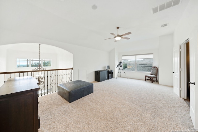 carpeted living room with ceiling fan, a healthy amount of sunlight, and vaulted ceiling