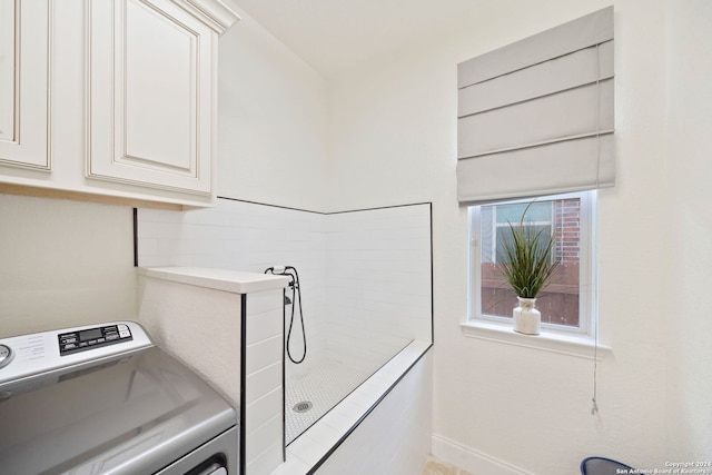 laundry room with cabinets and washer / clothes dryer