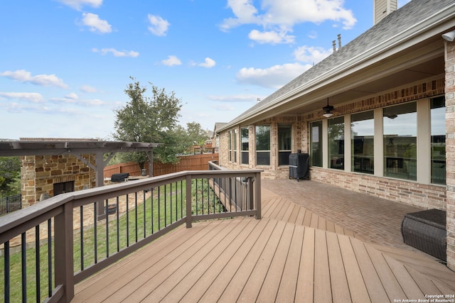 wooden deck featuring a yard, a patio, and ceiling fan