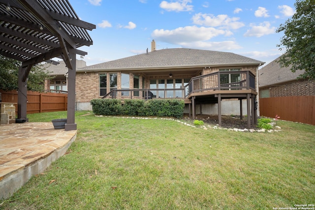 back of house with a pergola, a lawn, and a wooden deck