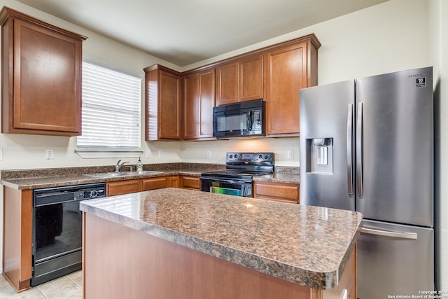 kitchen with black appliances, a center island, light tile patterned floors, and sink