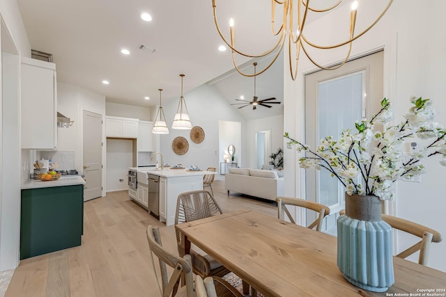 dining space with light hardwood / wood-style flooring, ceiling fan, lofted ceiling, and sink