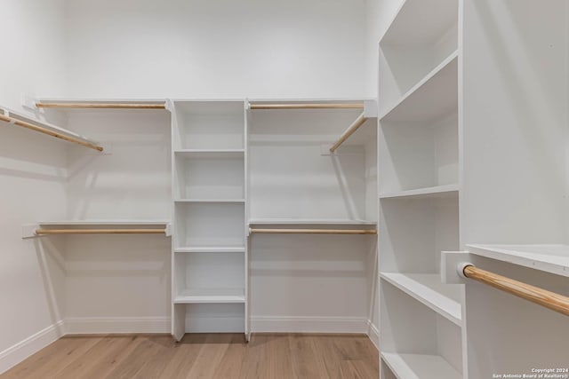 spacious closet featuring light hardwood / wood-style floors