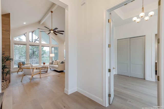 interior space with beam ceiling, high vaulted ceiling, light hardwood / wood-style flooring, and a notable chandelier