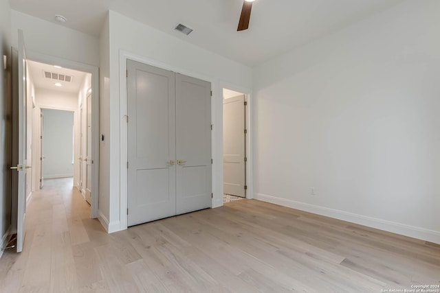 unfurnished bedroom featuring a closet, ceiling fan, and light hardwood / wood-style flooring