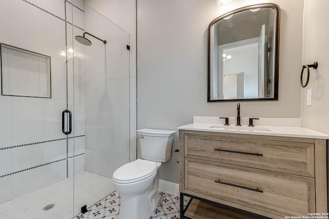 bathroom featuring tile patterned flooring, vanity, toilet, and walk in shower