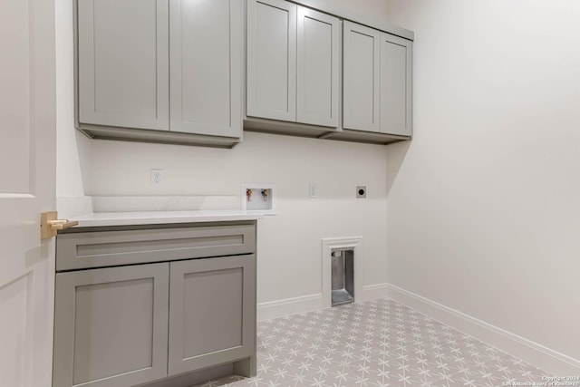 washroom featuring electric dryer hookup, hookup for a washing machine, and cabinets