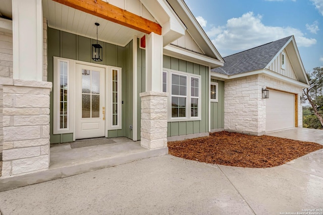 view of exterior entry with a garage