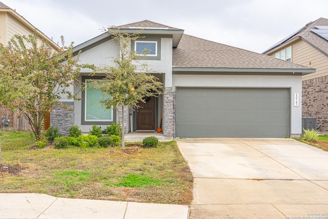 view of front of home featuring roof with shingles, central air condition unit, stucco siding, concrete driveway, and a garage