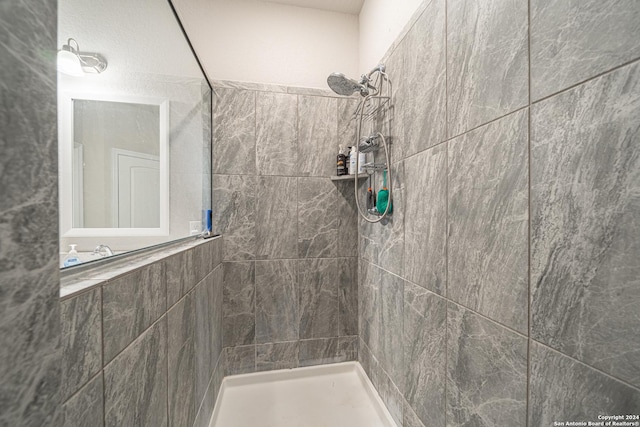 bathroom with tiled shower