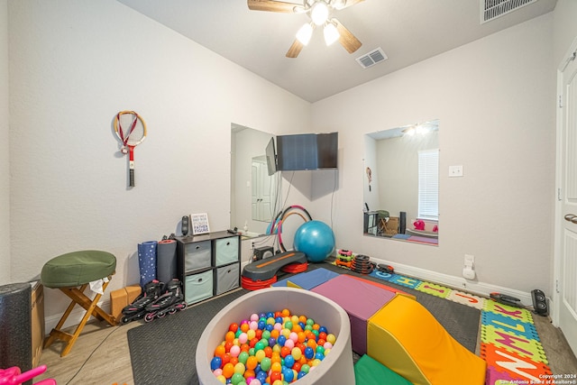 playroom with ceiling fan and light wood-type flooring