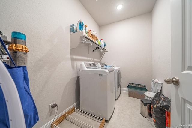 clothes washing area featuring independent washer and dryer