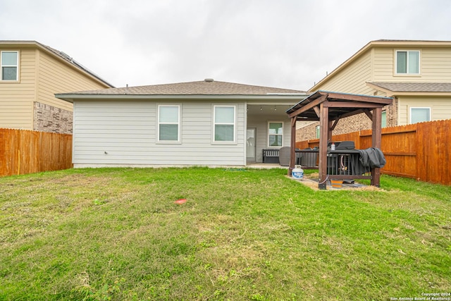 rear view of property with a patio area and a yard