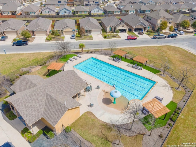 view of pool with a residential view and fence