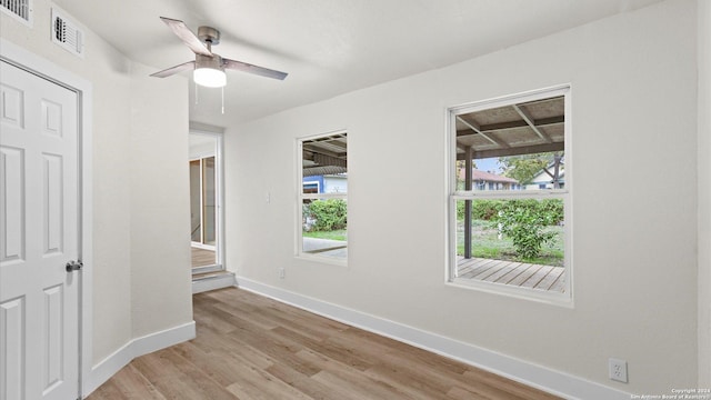 unfurnished bedroom featuring ceiling fan, light hardwood / wood-style floors, and multiple windows